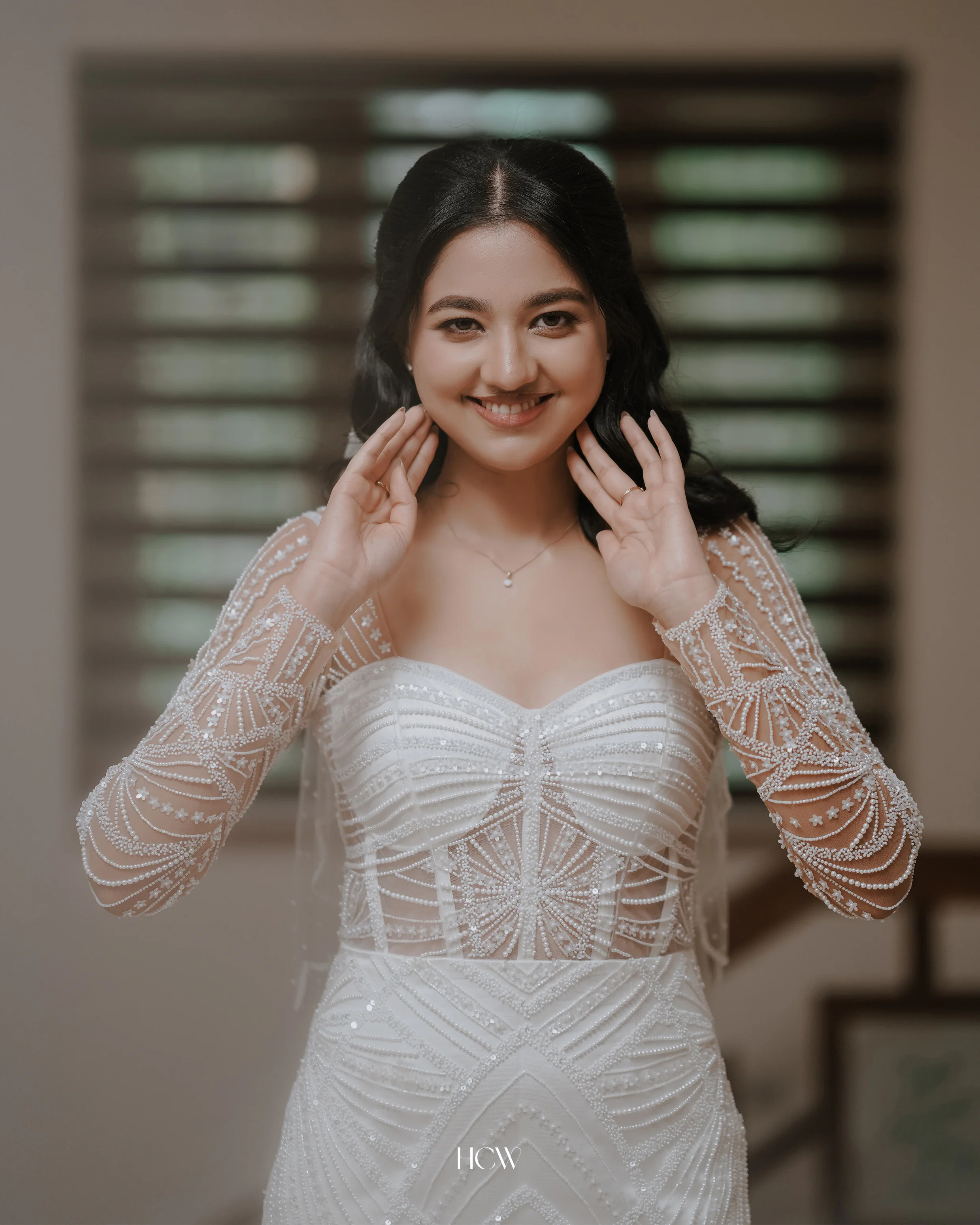 Bride smiling while getting ready